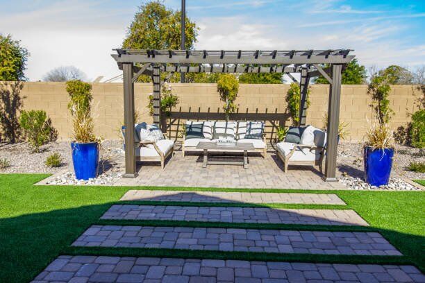 rear yard arbor over patio furniture